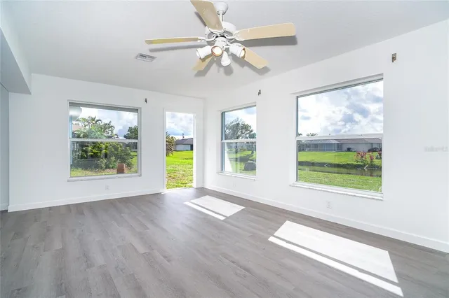 a kitchen that has a lot of cabinets a sink and appliances in it