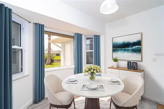 an empty room with a window and wooden floor