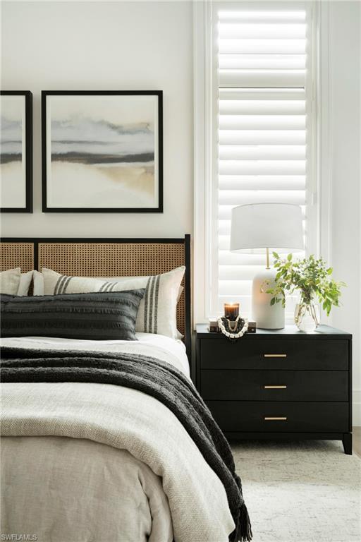 6704 Newport Road Naples, FL 34109 - Photo 20 of 47 a bed sitting in a bedroom next to a window