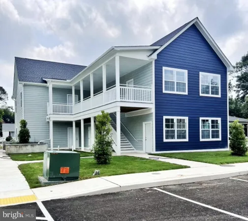 a view of brick house with a yard and large windows