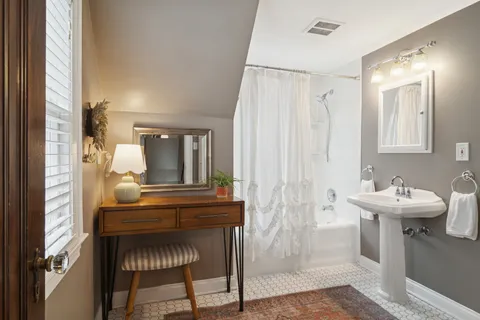 a view of a bathroom with dual sinks