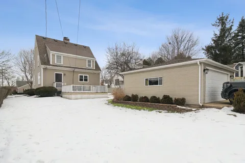 a view of a house with a yard covered in snow