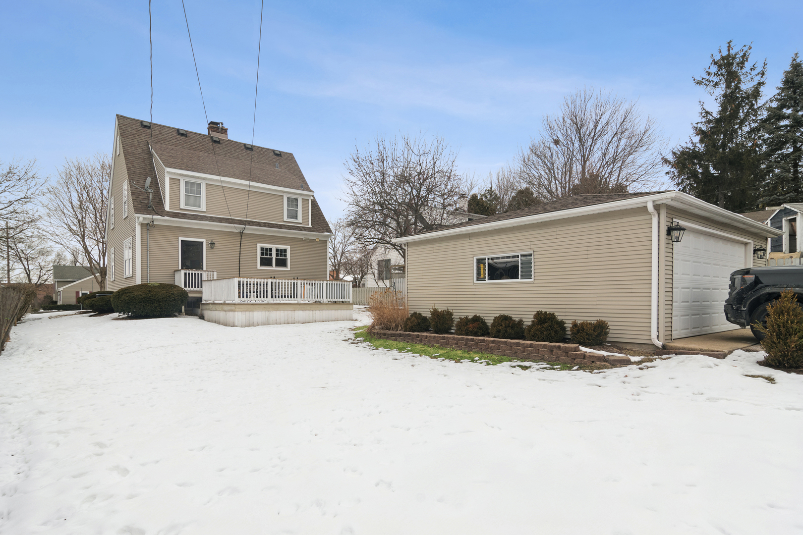 131 Walton Street Barrington, IL 60010 - Photo 22 of 26 a view of a house with a yard covered in snow
