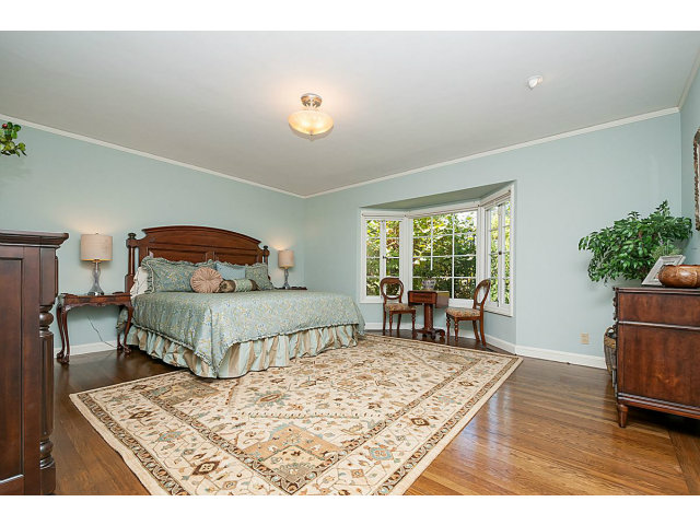 615 Chiltern Road Hillsborough, CA 94010 - Photo 12 of 25 a bedroom with a bed a table and chair