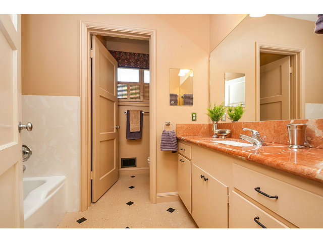 615 Chiltern Road Hillsborough, CA 94010 - Photo 15 of 25 a bathroom with a sink a mirror and a bathtub