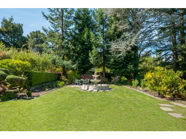 615 Chiltern Road Hillsborough, CA 94010 - Photo 19 of 25 a view of a chair and table on the garden