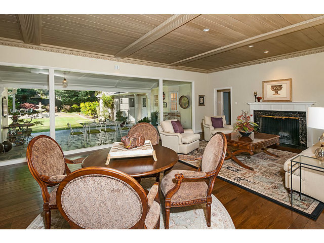 615 Chiltern Road Hillsborough, CA 94010 - Photo 6 of 25 a dining room with furniture a fireplace and wooden floor