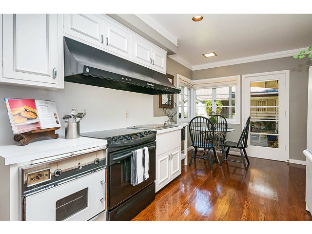 615 Chiltern Road Hillsborough, CA 94010 - Photo 9 of 25 a kitchen with stainless steel appliances a stove a table and chairs