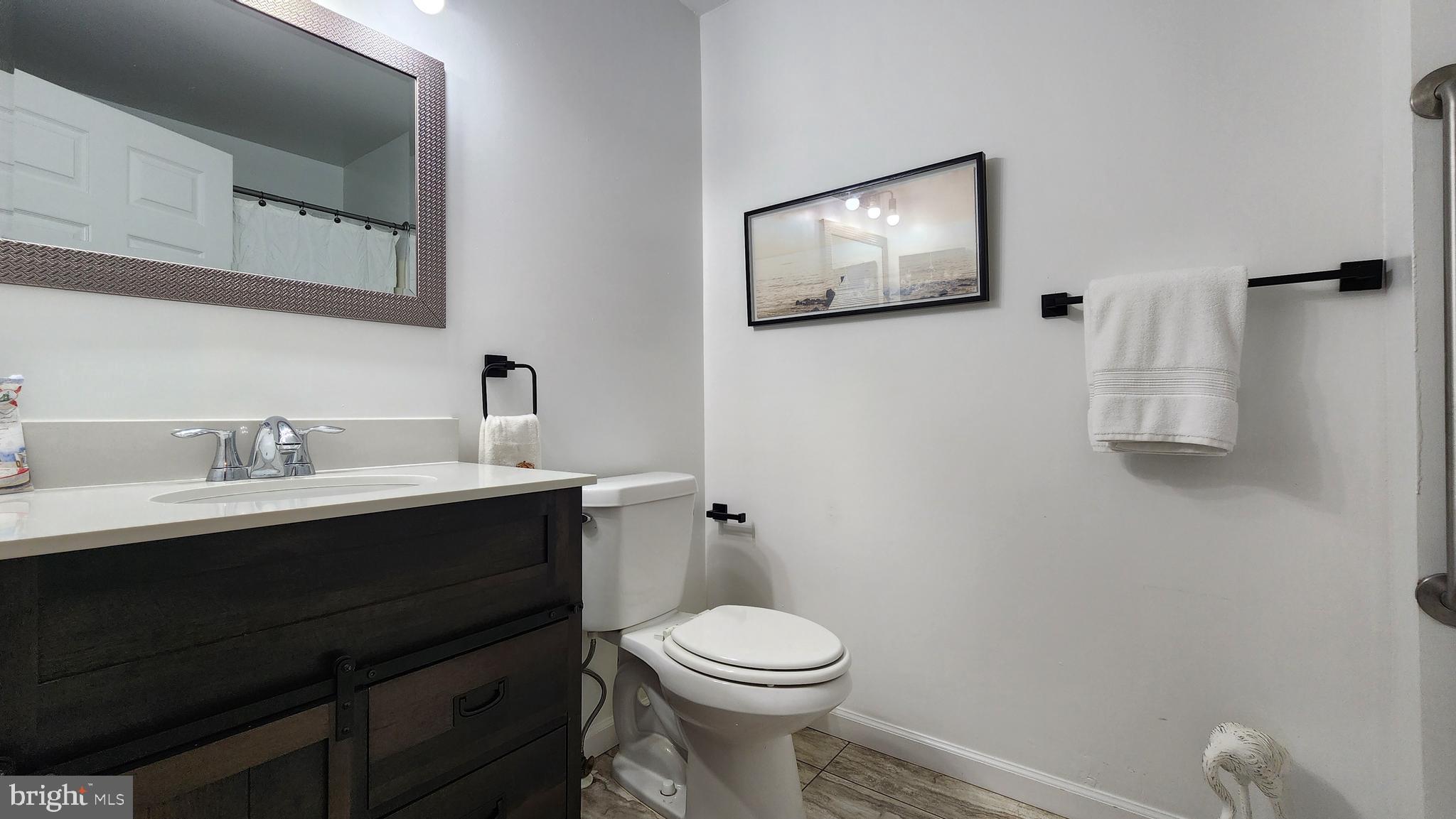 520 Bay Street Berlin, MD 21811 - Photo 11 of 22 a bathroom with a toilet sink and mirror