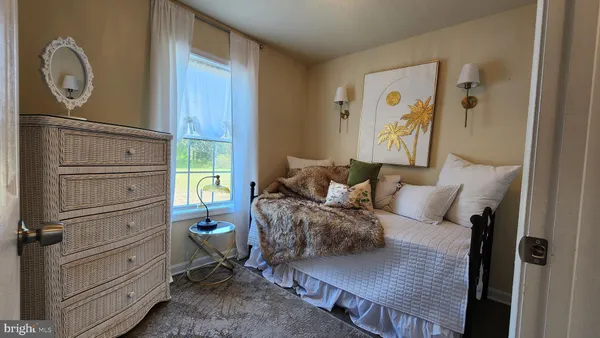 a bed room with a bed window and mirror