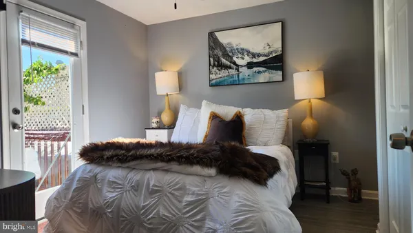 a bedroom with a bed and a painting on the wall