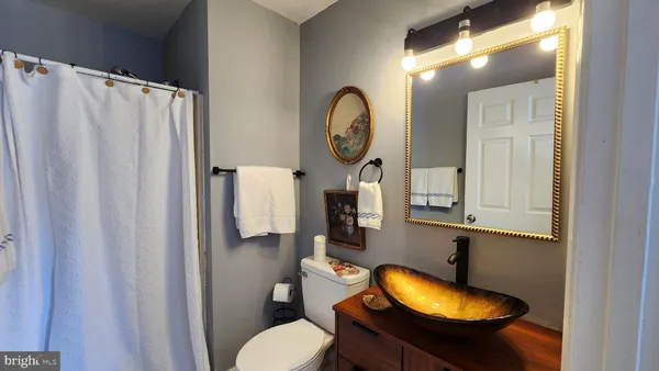 a bathroom with a sink toilet and mirror