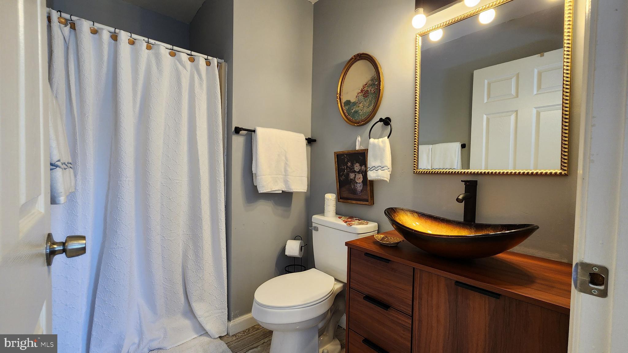 520 Bay Street Berlin, MD 21811 - Photo 18 of 22 a bathroom with a toilet and a sink