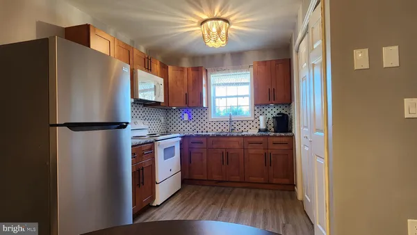 a kitchen with stainless steel appliances granite countertop a refrigerator a sink and dishwasher