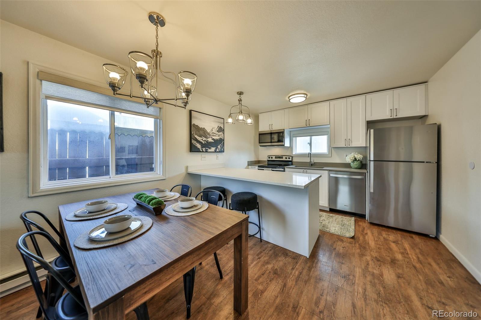 233 Fraser Avenue, Unit R1 Fraser, CO 80442 - Photo 12 of 23 a kitchen with sink refrigerator and dining table