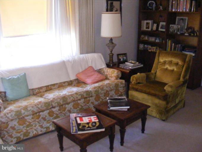 12013 Claridge Road Silver Spring, MD 20902 - Photo 2 of 13 a living room with furniture and a lamp
