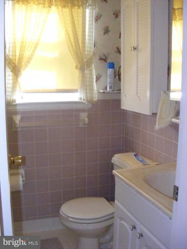 12013 Claridge Road Silver Spring, MD 20902 - Photo 11 of 13 a bathroom with a toilet sink and mirror