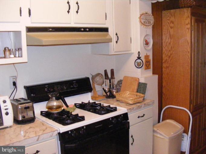 12013 Claridge Road Silver Spring, MD 20902 - Photo 5 of 13 a kitchen with a stove and a refrigerator