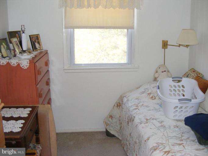 12013 Claridge Road Silver Spring, MD 20902 - Photo 8 of 13 a bedroom with a bed and a window