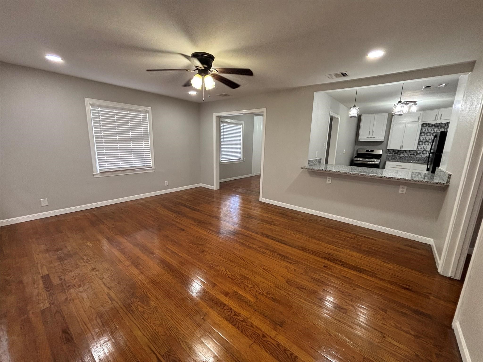 1401 Austin Street La Marque, TX 77568 - Photo 2 of 16 a view of a room with wooden floor and chandelier