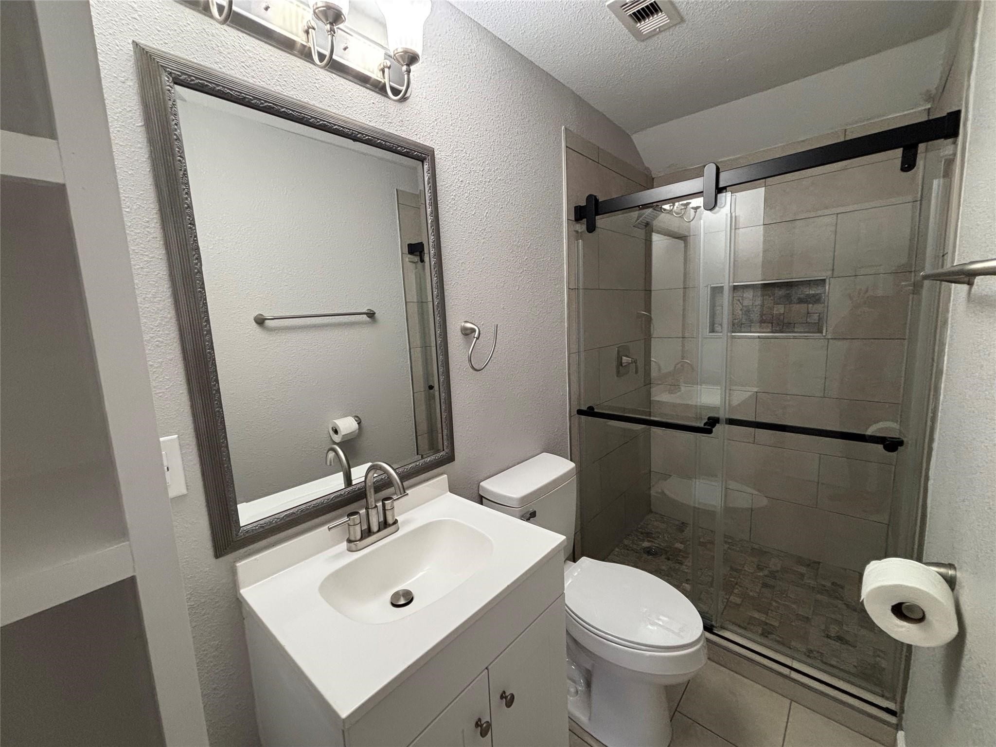 1401 Austin Street La Marque, TX 77568 - Photo 9 of 16 a bathroom with a sink toilet and shower