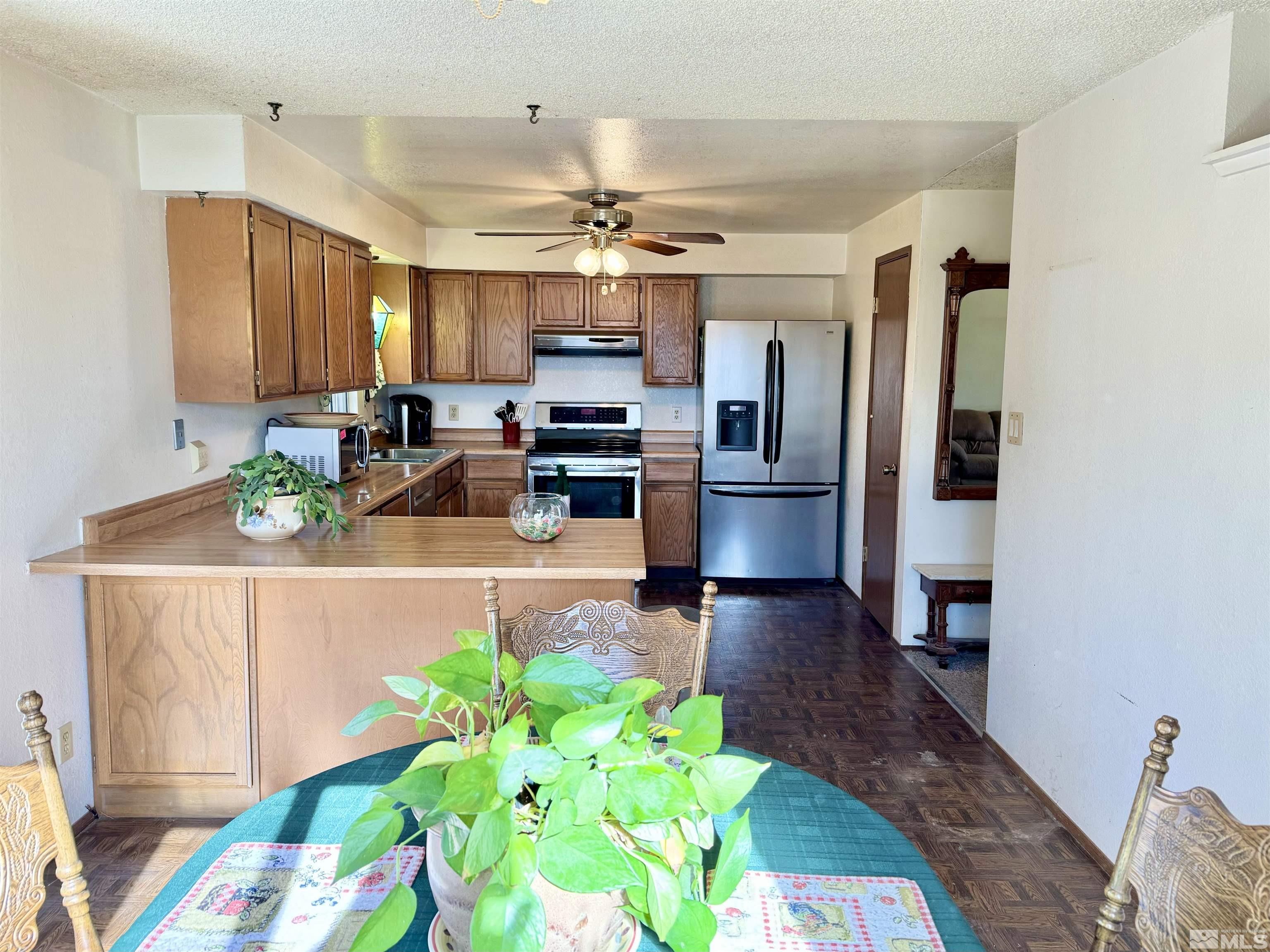 1655 Alamo Street Reno, NV 89503 - Photo 12 of 38 a living room with kitchen island furniture and a chandelier