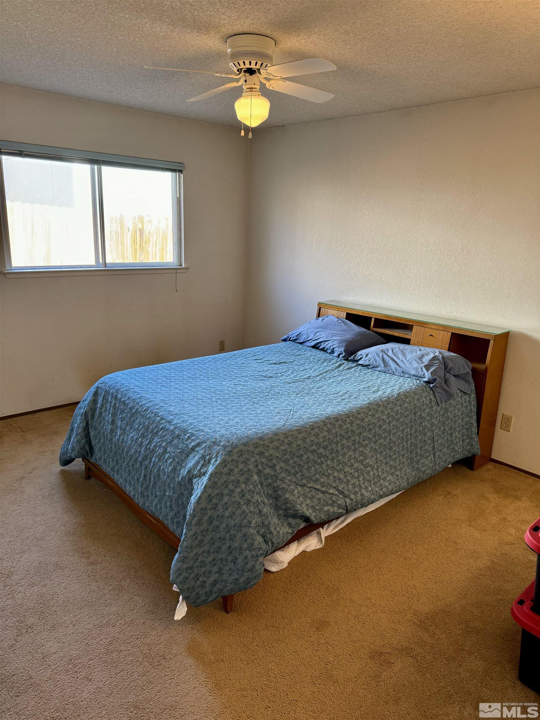 1655 Alamo Street Reno, NV 89503 - Photo 19 of 38 a bed sitting in a bedroom next to a window