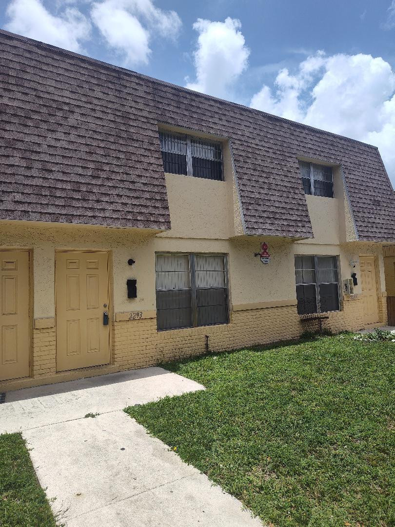 2293 Northwest 59th Way Lauderhill, FL 33313 - Photo 1 of 9 a front view of a house with a yard and garage