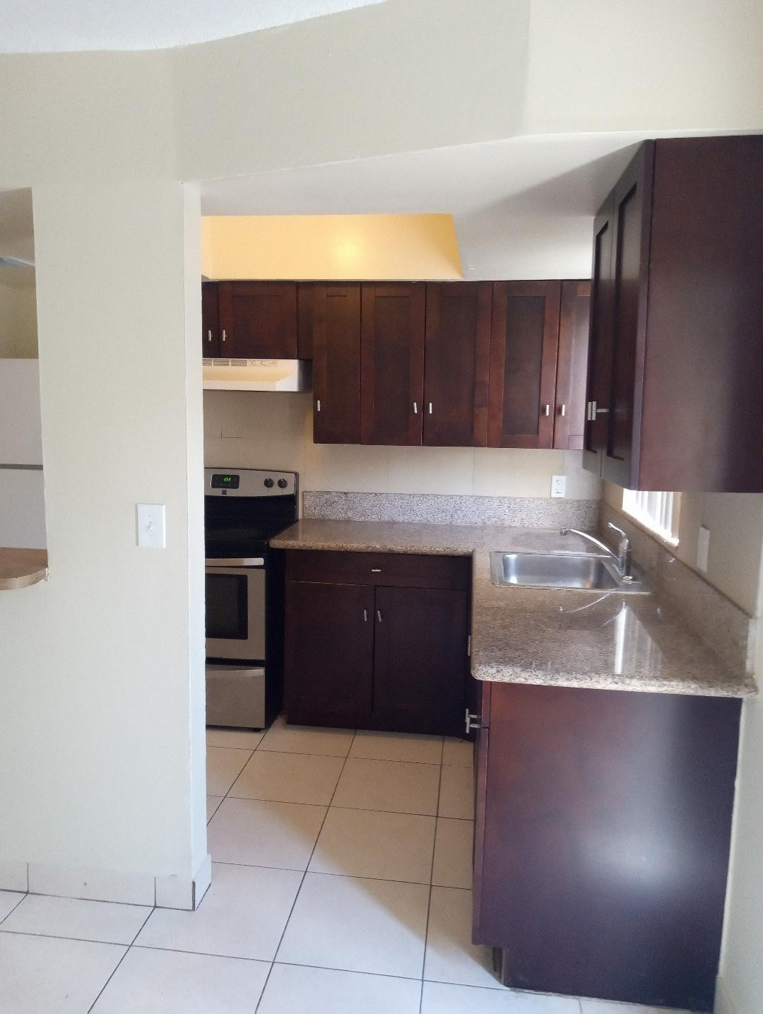 2293 Northwest 59th Way Lauderhill, FL 33313 - Photo 2 of 9 a kitchen with stainless steel appliances granite countertop a refrigerator and a stove
