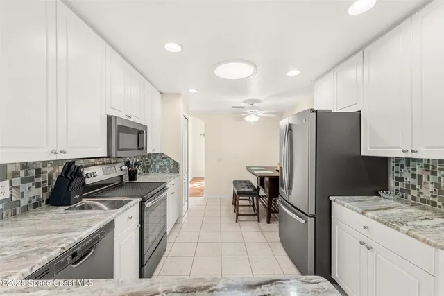 an aerial view of residential houses with outdoor space and river