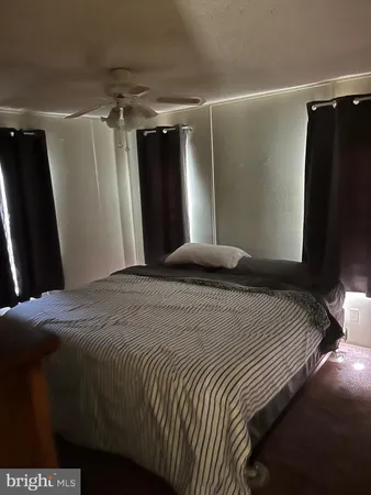 a bedroom with a bed and a mirror