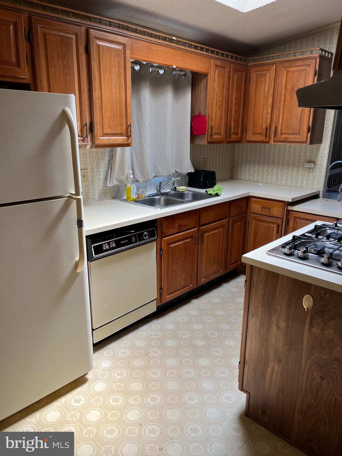 4191 Lake Road Newfield, NJ 08344 - Photo 7 of 9 a kitchen with stainless steel appliances granite countertop a sink stove and refrigerator