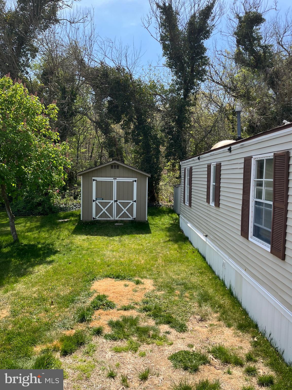 4191 Lake Road Newfield, NJ 08344 - Photo 8 of 9 a backyard of a house with a garden and trees