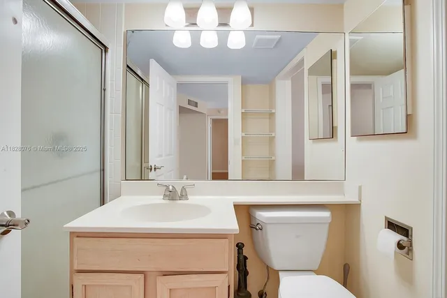 a bathroom with a sink a mirror and a toilet