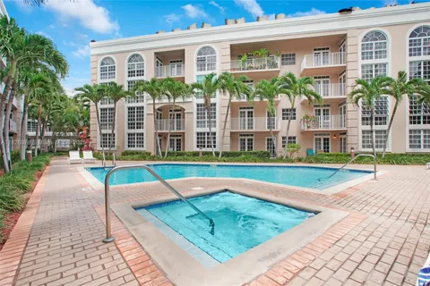 a view of a house with a swimming pool and a yard