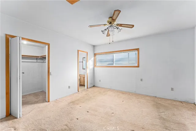 a view of an empty room with a ceiling fan