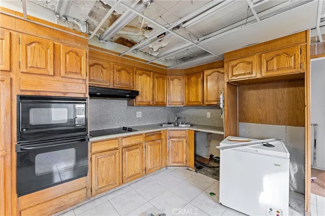 a kitchen with cabinets and appliances