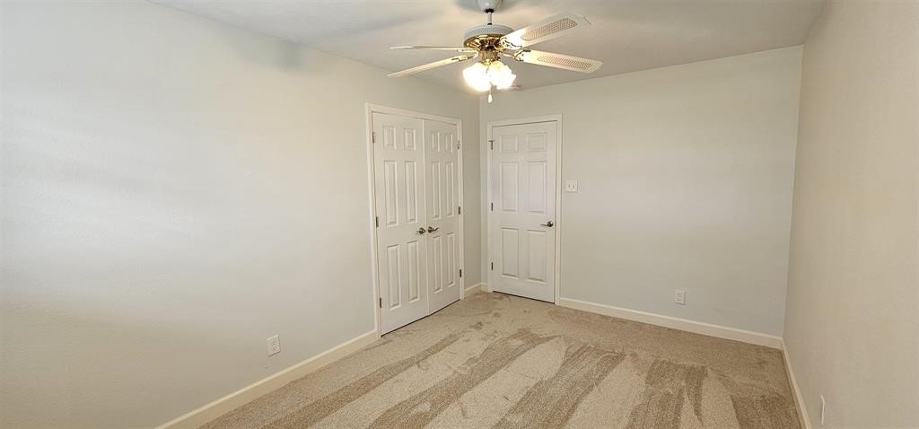 1364 Beagle Road Orange, TX 77632 - Photo 11 of 25 a view of a room with a ceiling fan and a window