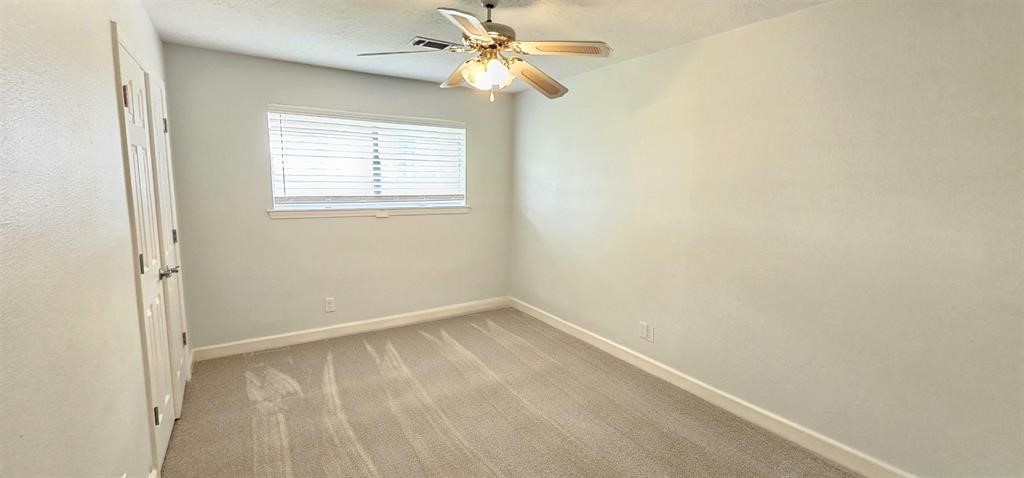 1364 Beagle Road Orange, TX 77632 - Photo 13 of 25 an empty room with a window and a fan