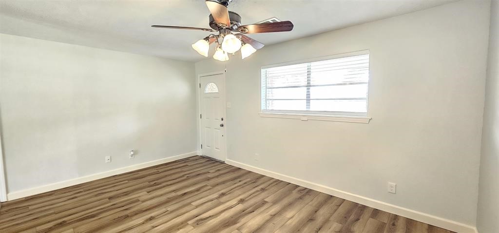 1364 Beagle Road Orange, TX 77632 - Photo 2 of 25 wooden floor in an empty room with a window