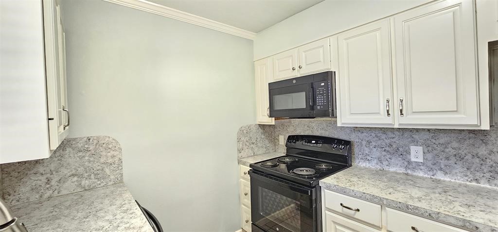 1364 Beagle Road Orange, TX 77632 - Photo 7 of 25 a kitchen with a stove and a microwave