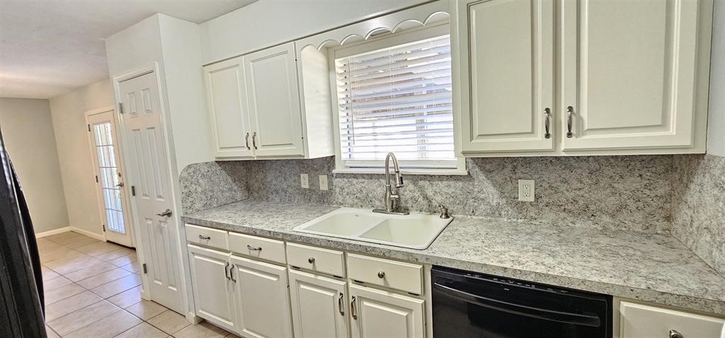 1364 Beagle Road Orange, TX 77632 - Photo 8 of 25 a kitchen with granite countertop white cabinets and a stainless steel appliances