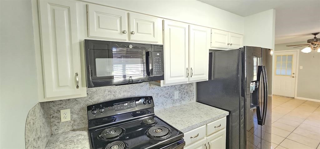 1364 Beagle Road Orange, TX 77632 - Photo 9 of 25 a kitchen with stainless steel appliances granite countertop a refrigerator and a stove