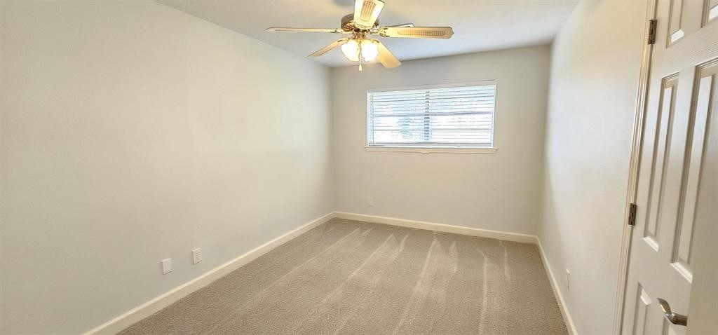 1364 Beagle Road Orange, TX 77632 - Photo 10 of 25 an empty room with a window and a fan