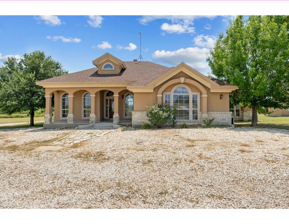 12015 Arnhamn Lane Manor, TX 78653 - Photo 1 of 35 a front view of a house with a yard