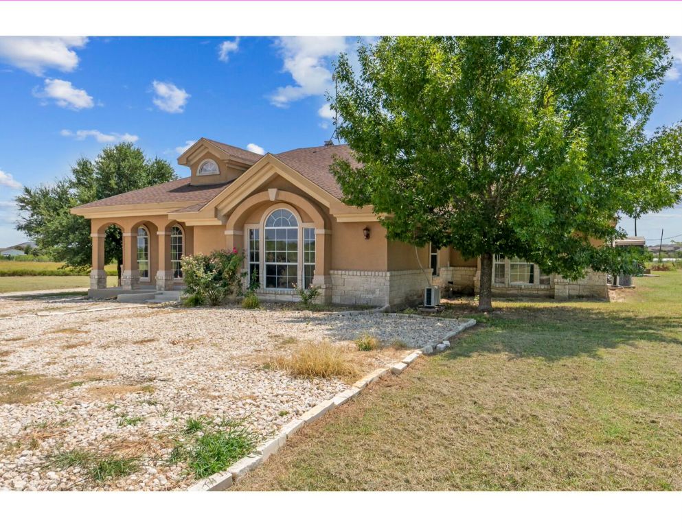 12015 Arnhamn Lane Manor, TX 78653 - Photo 2 of 35 a front view of a house with a garden