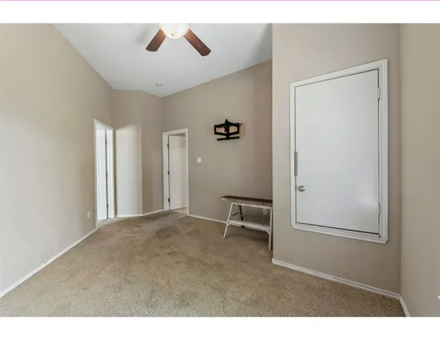 a view of a livingroom with a ceiling fan and window