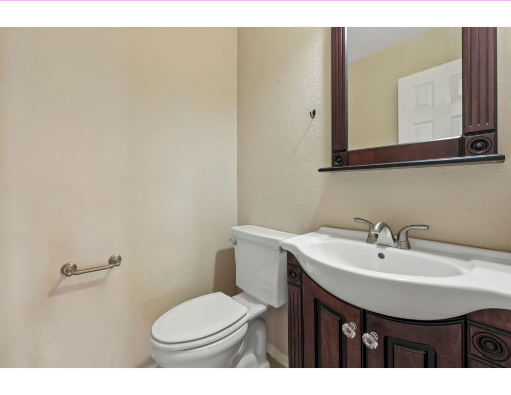 12015 Arnhamn Lane Manor, TX 78653 - Photo 10 of 35 a bathroom with a sink a mirror and a toilet