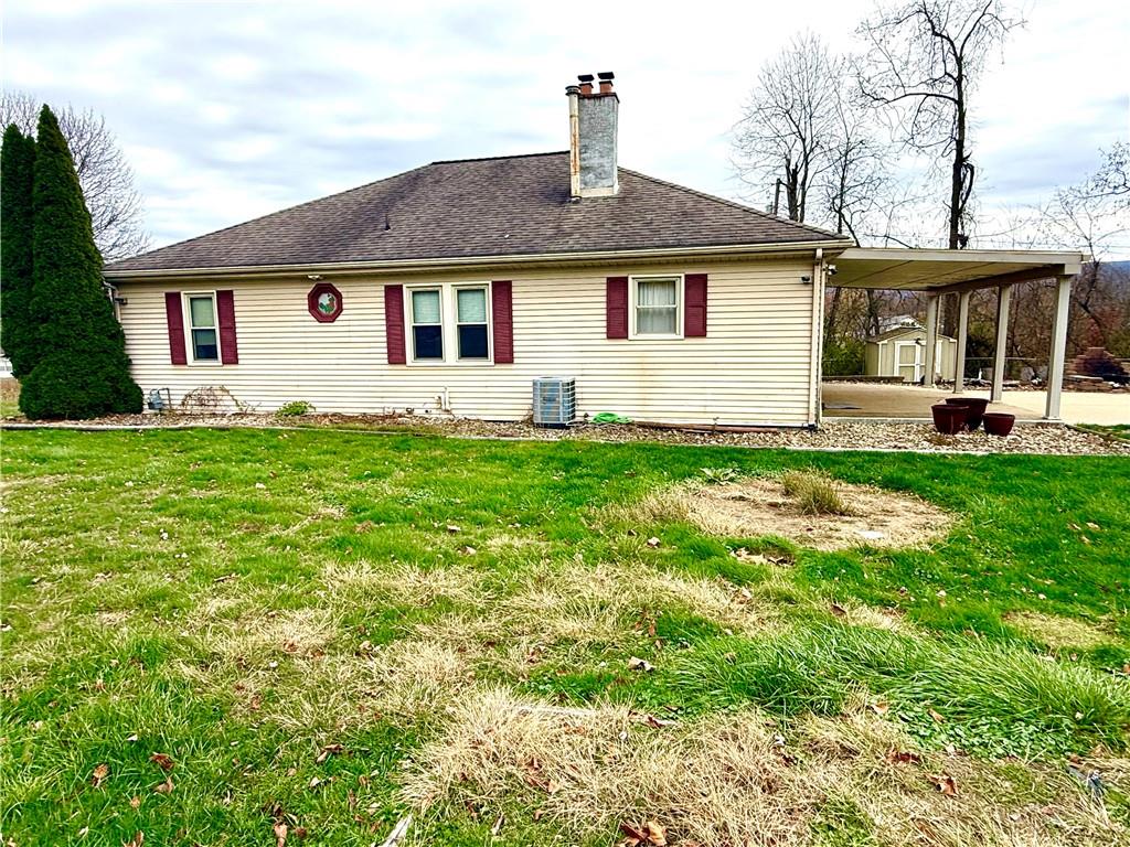 a view of a house with a yard and sitting area
