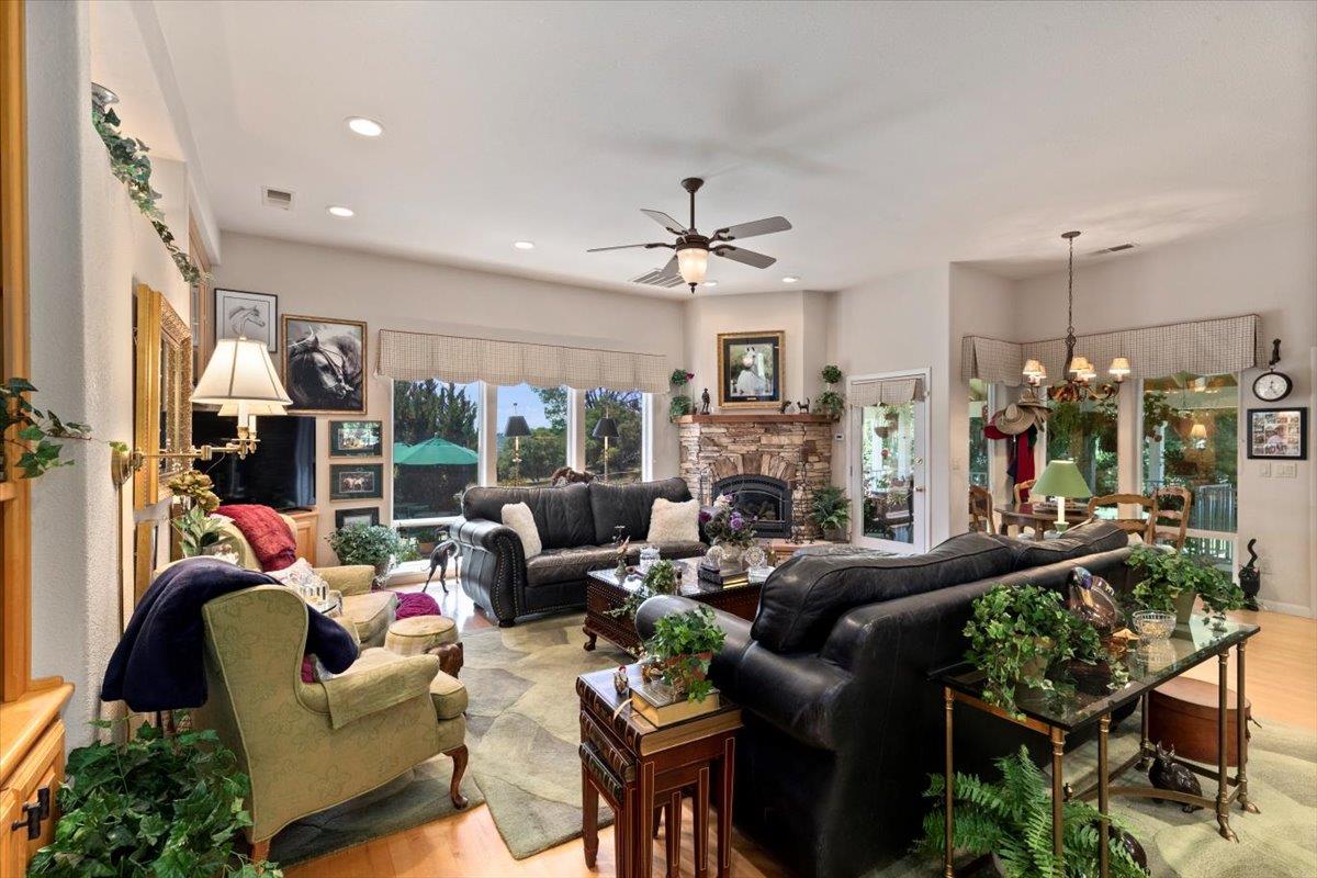 4558 Country View Court Cool, CA 95614 - Photo 18 of 71 a living room with furniture a fireplace and a chandelier